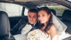 portrait of the happy bride and groom in the car